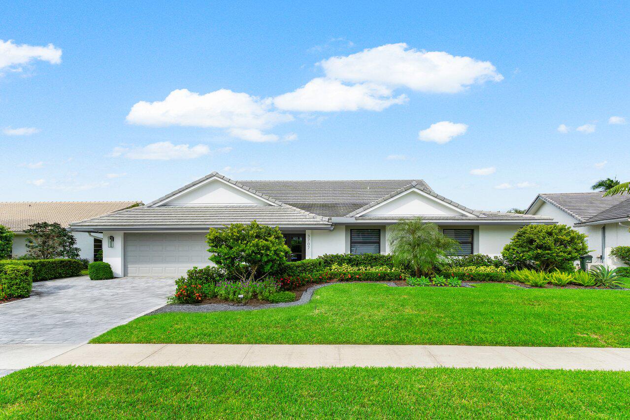 3707 Red Maple Circle Delray Beach, FL 33445 - Photo 1 of 39 a front view of a house with a garden