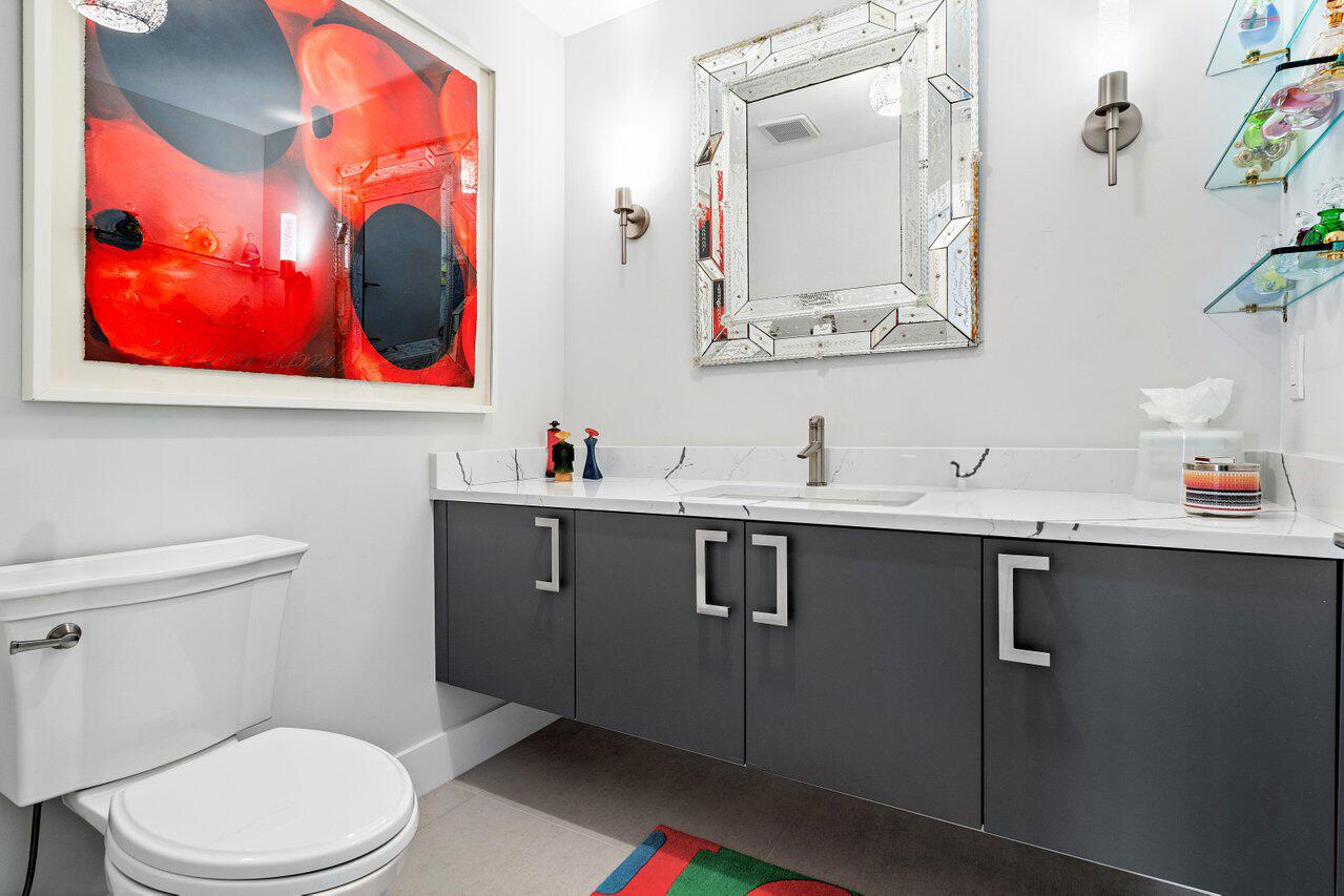 3707 Red Maple Circle Delray Beach, FL 33445 - Photo 19 of 39 a bathroom with a toilet a sink and mirror