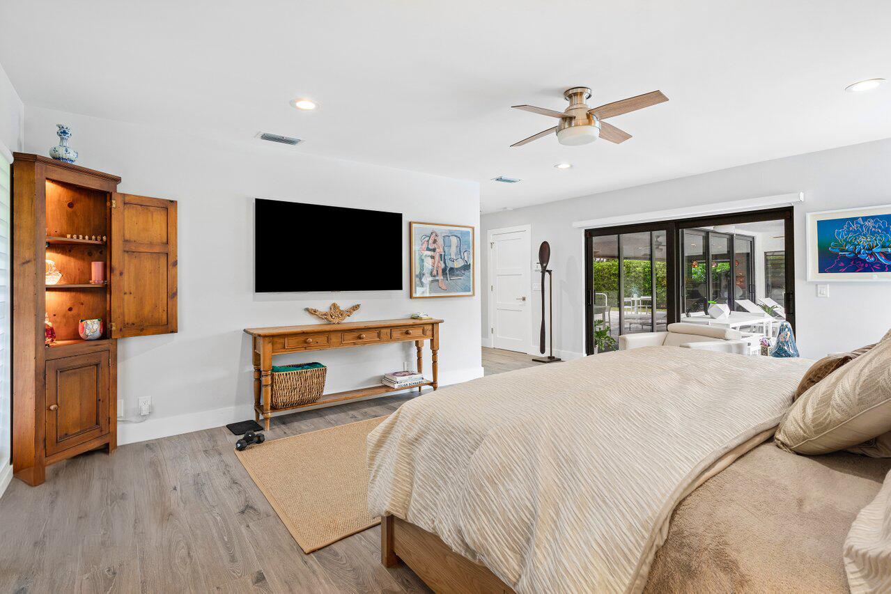 3707 Red Maple Circle Delray Beach, FL 33445 - Photo 22 of 39 a bedroom with a bed and a flat screen tv