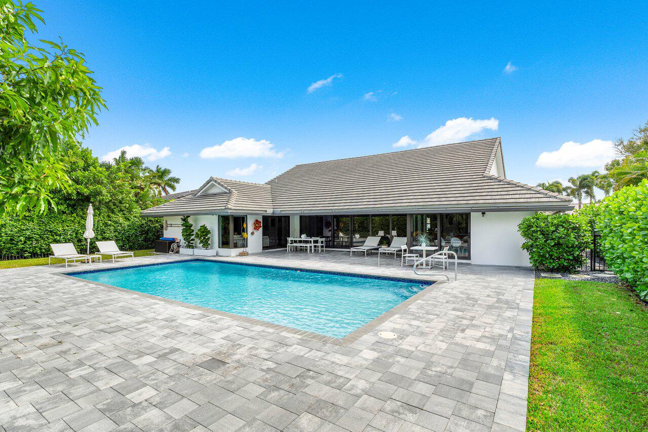 3707 Red Maple Circle Delray Beach, FL 33445 - Photo 32 of 39 a front view of a house with swimming pool having outdoor seating