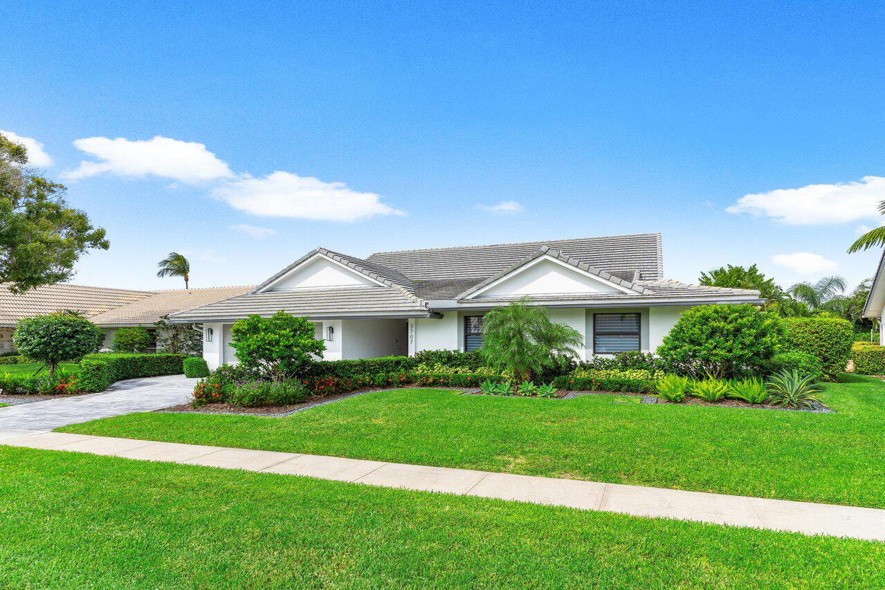 3707 Red Maple Circle Delray Beach, FL 33445 - Photo 39 of 39 a view of house in front of a big yard with potted plants