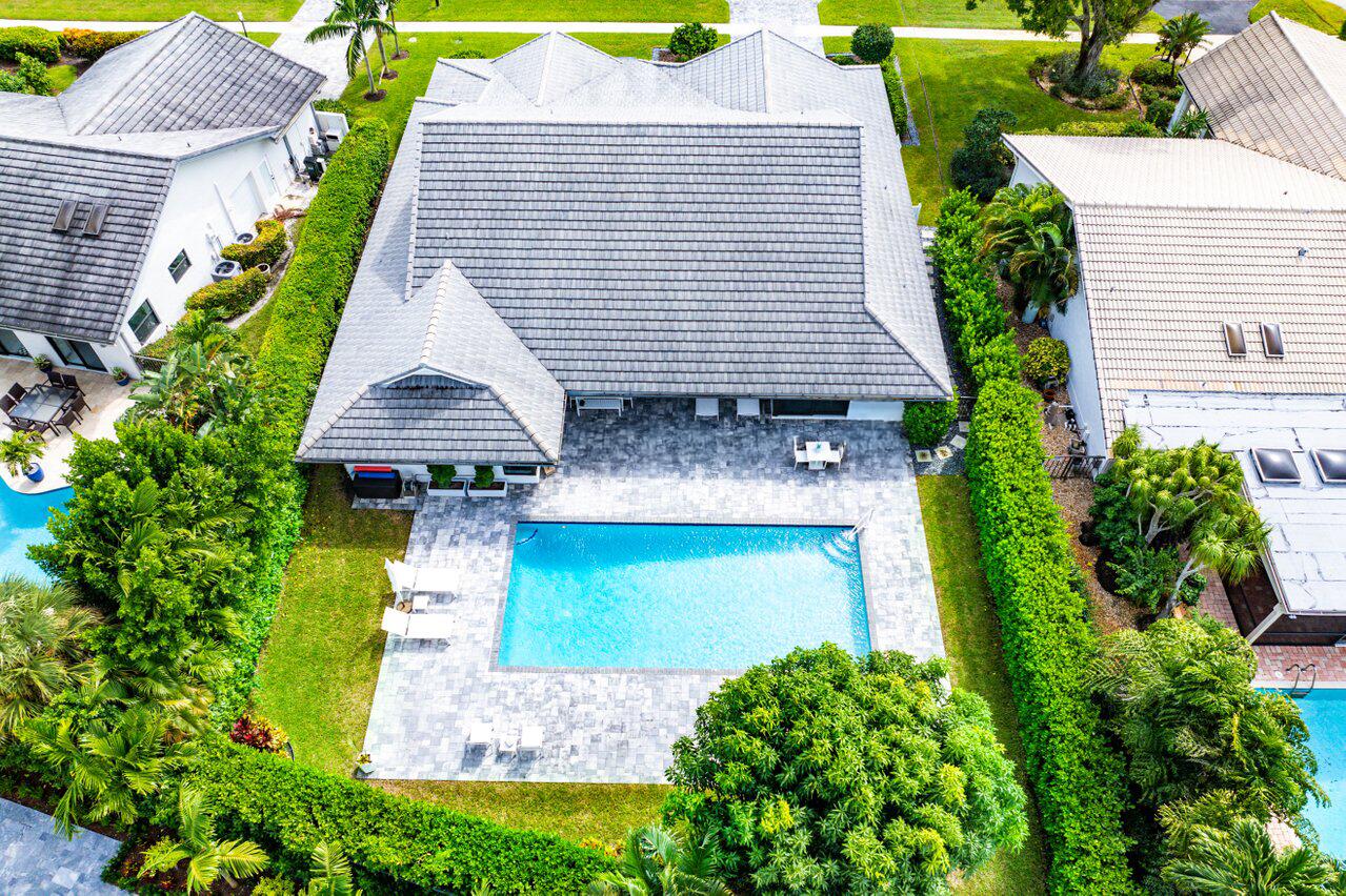 3707 Red Maple Circle Delray Beach, FL 33445 - Photo 4 of 39 a aerial view of a house with a yard and potted plants