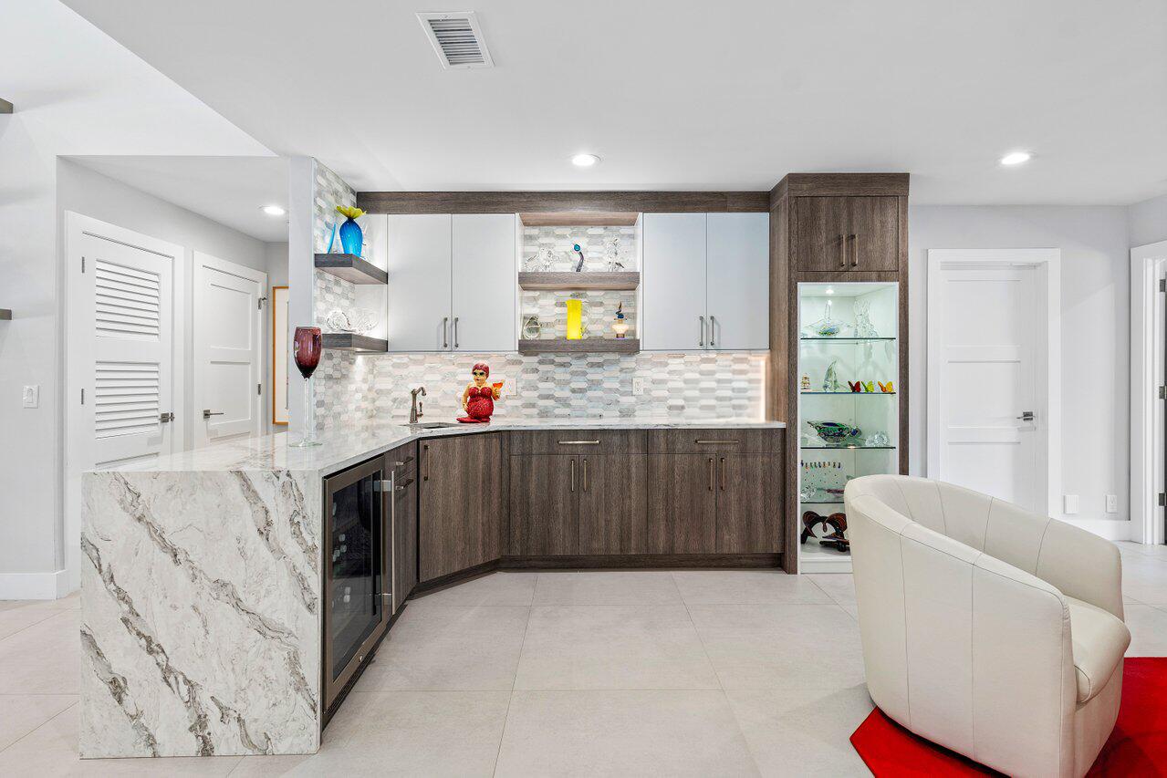3707 Red Maple Circle Delray Beach, FL 33445 - Photo 9 of 39 a kitchen with stainless steel appliances kitchen island granite countertop a sink and cabinets