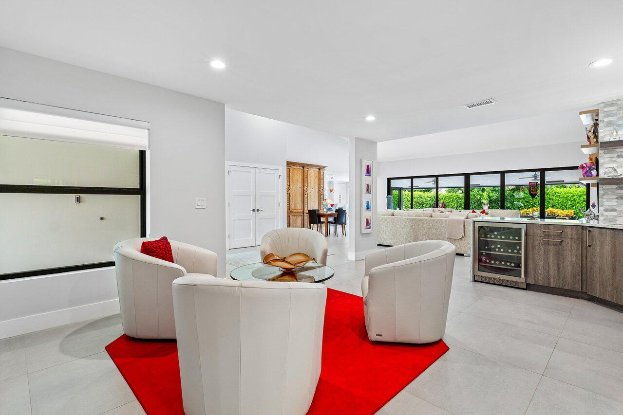 3707 Red Maple Circle Delray Beach, FL 33445 - Photo 10 of 39 a living room with furniture a large window with kitchen view