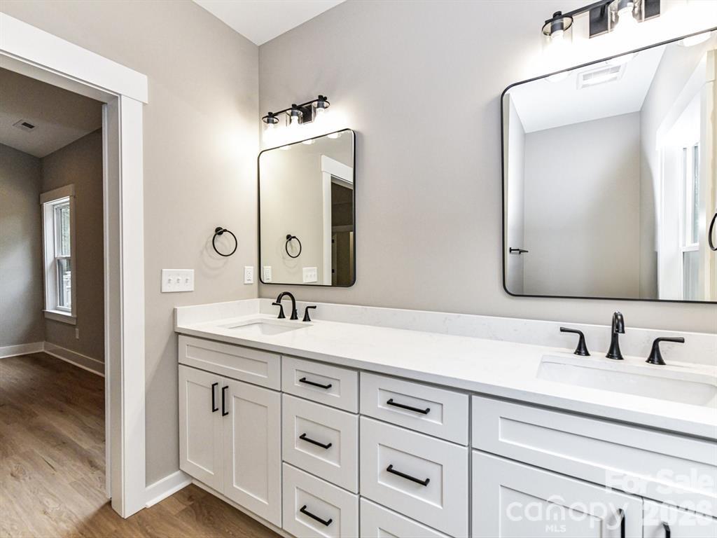 6720 Jesse Rushing Road Marshville, NC 28103 - Photo 15 of 28 a bathroom with double vanity sinks and a mirror