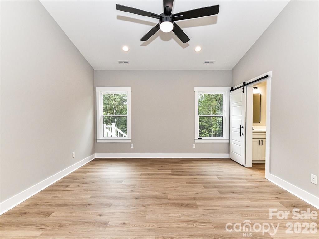 6720 Jesse Rushing Road Marshville, NC 28103 - Photo 16 of 28 a view of an empty room with a window and wooden floor