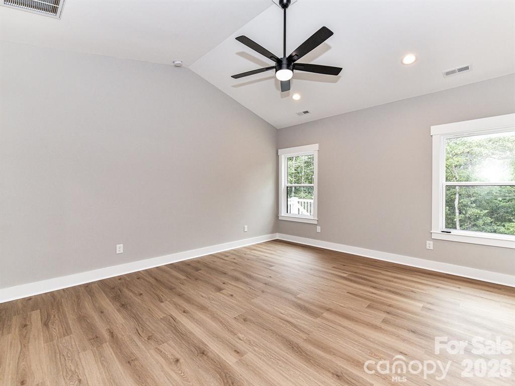 6720 Jesse Rushing Road Marshville, NC 28103 - Photo 17 of 28 an empty room with wooden floor and windows