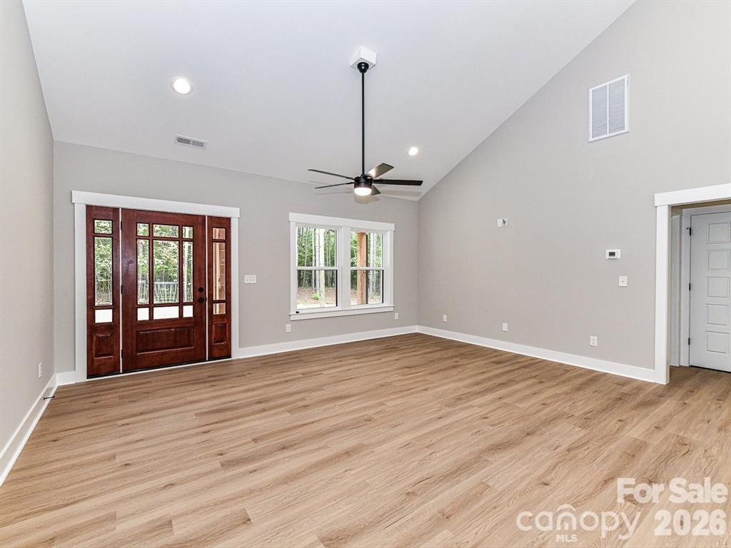 6720 Jesse Rushing Road Marshville, NC 28103 - Photo 4 of 28 a view of empty room with wooden floor and fan