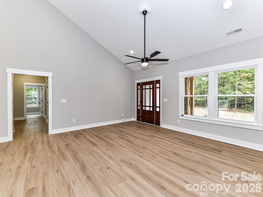 6720 Jesse Rushing Road Marshville, NC 28103 - Photo 5 of 28 a view of empty room with wooden floor and fan