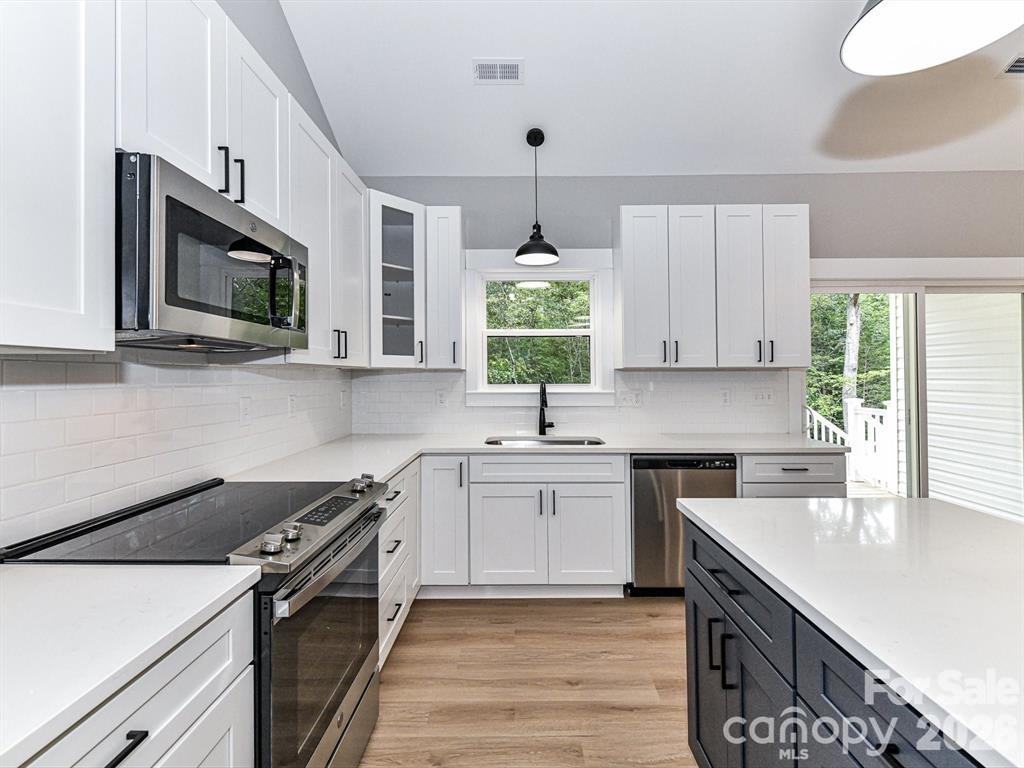6720 Jesse Rushing Road Marshville, NC 28103 - Photo 6 of 28 a kitchen with a sink stove and microwave