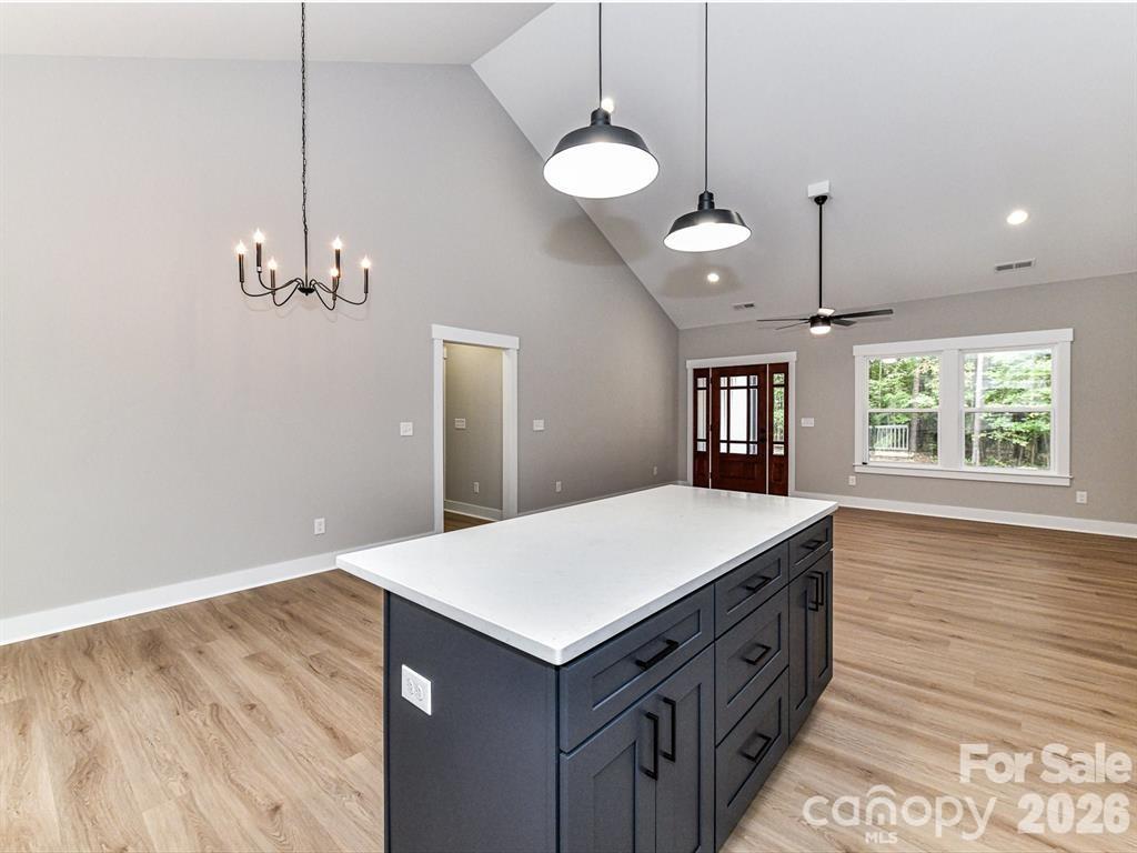 6720 Jesse Rushing Road Marshville, NC 28103 - Photo 7 of 28 a kitchen with a stove chandelier and wooden floor