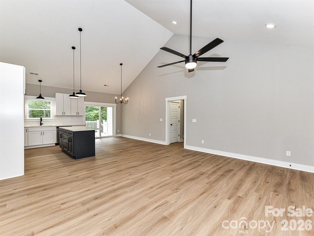 6720 Jesse Rushing Road Marshville, NC 28103 - Photo 9 of 28 a view of a kitchen with a sink a ceiling fan and wooden floor