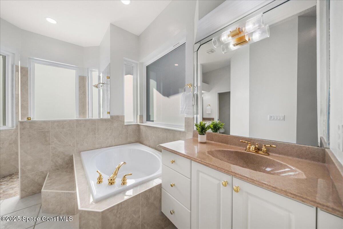 4329 Collingtree Drive Rockledge, FL 32955 - Photo 16 of 36 a bathroom with a granite countertop sink and a mirror