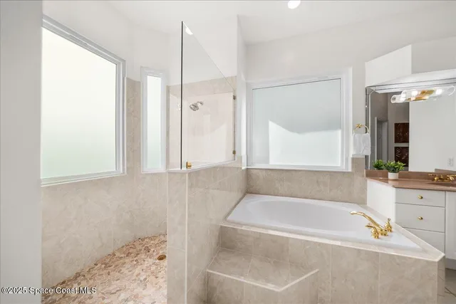 a bathroom with a bathtub and a shower