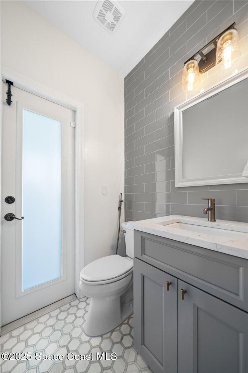 4329 Collingtree Drive Rockledge, FL 32955 - Photo 19 of 36 a bathroom with a sink a toilet and a mirror