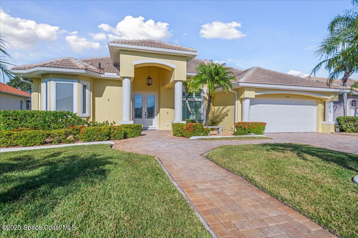 4329 Collingtree Drive Rockledge, FL 32955 - Photo 2 of 36 a front view of a house with garden