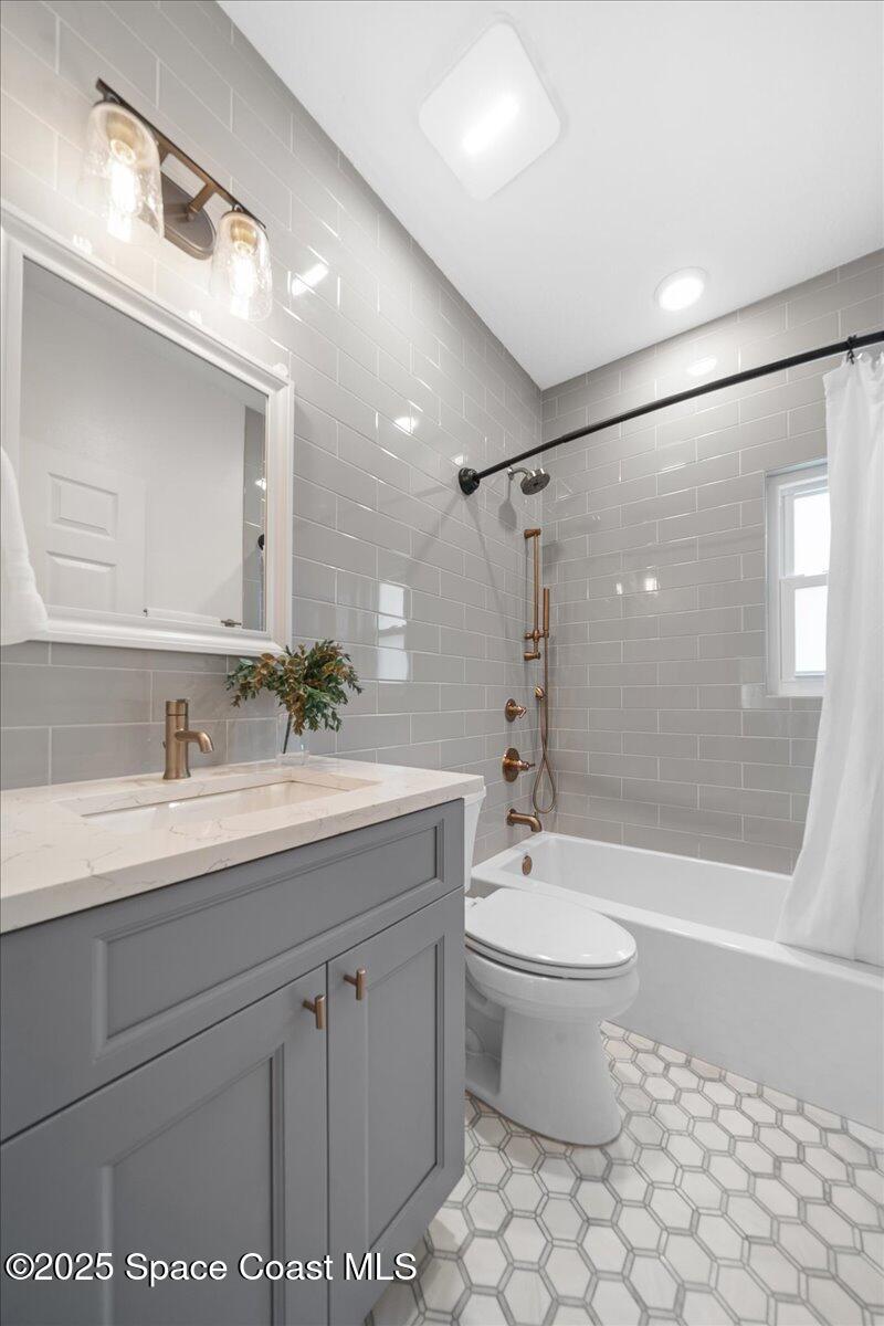 4329 Collingtree Drive Rockledge, FL 32955 - Photo 21 of 36 a bathroom with a granite countertop sink a toilet a mirror and shower