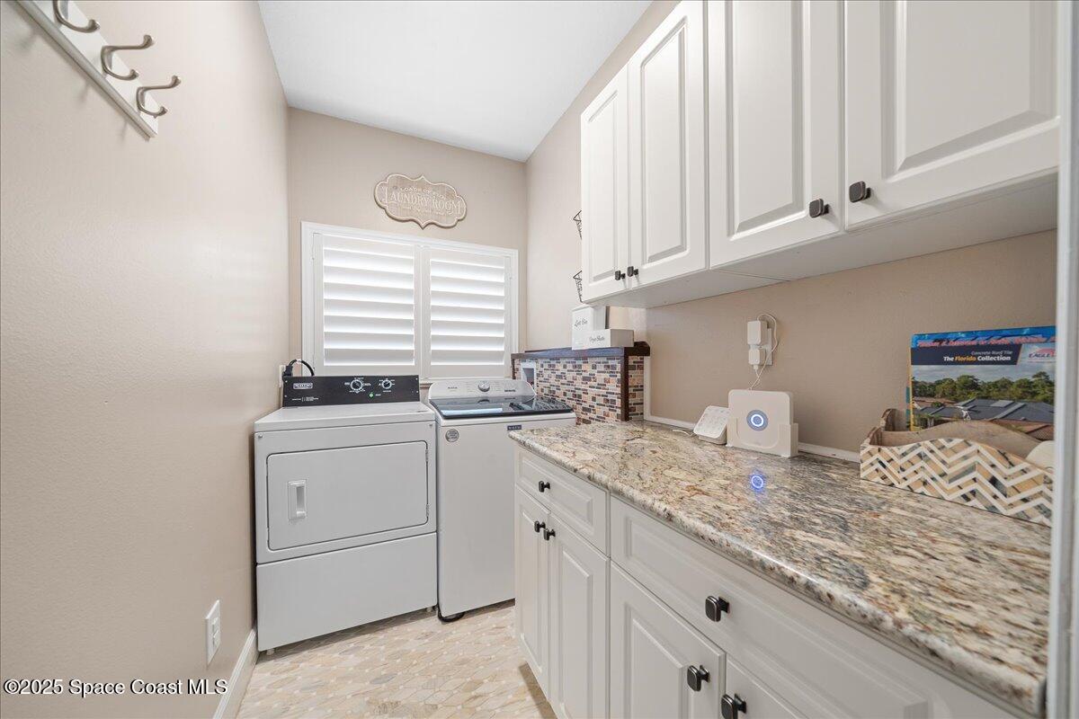 4329 Collingtree Drive Rockledge, FL 32955 - Photo 22 of 36 a kitchen with granite countertop white cabinets and white appliances
