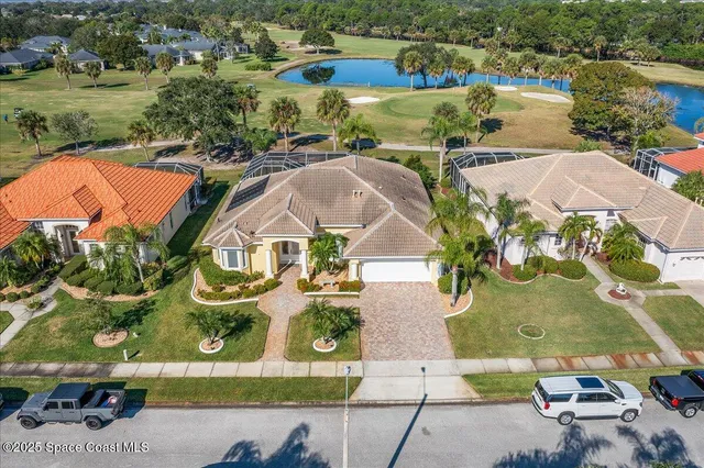 an aerial view of residential houses with outdoor space and swimming pool