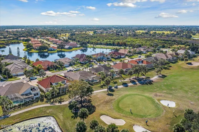 an aerial view of a residential houses with outdoor space