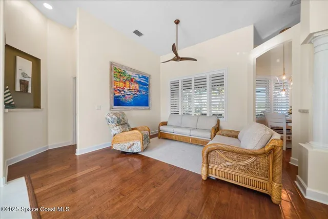 a living room with furniture and wooden floor