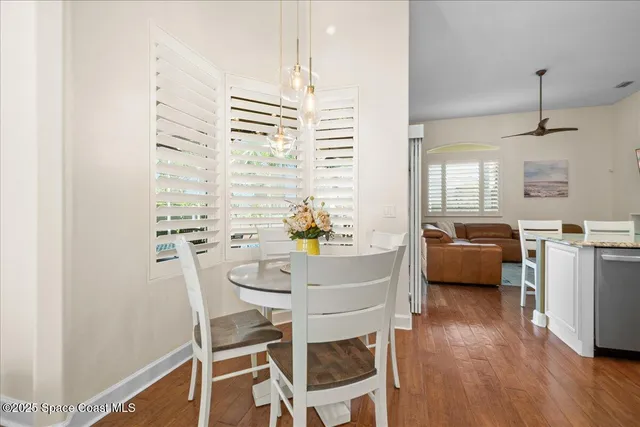 a dining room with furniture and wooden floor
