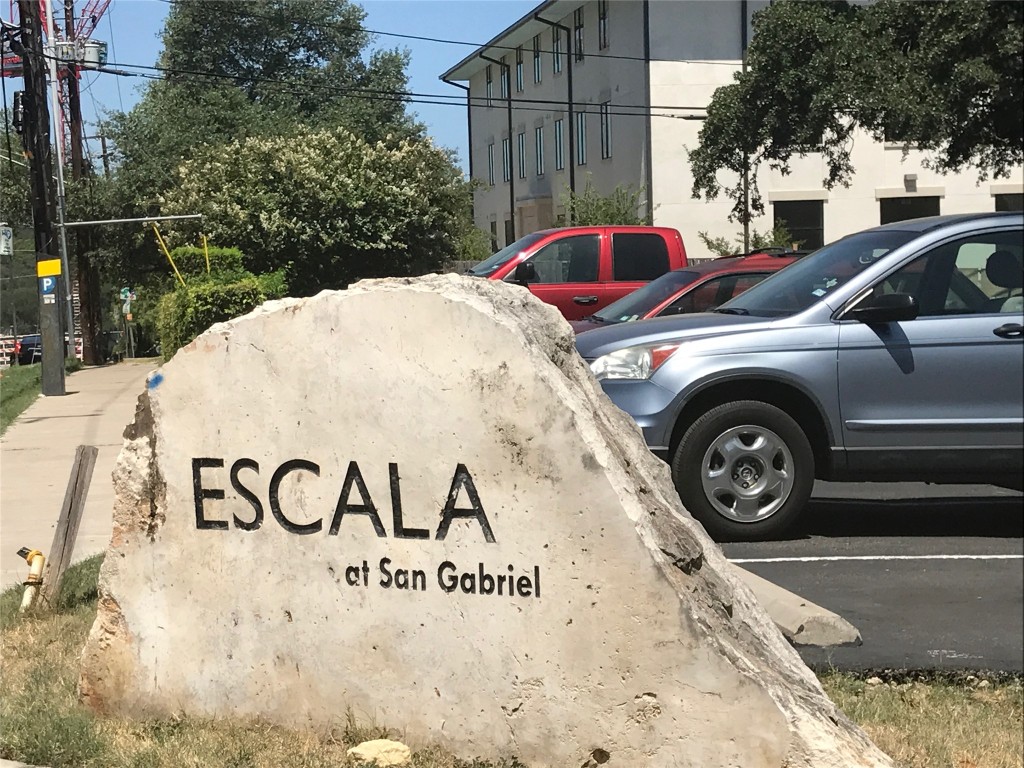 1000 West 26th Street, Unit 106 Austin, TX 78705 - Photo 1 of 12 a view of a wooden wall with a sign board