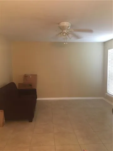 a view of a house with backyard and trees