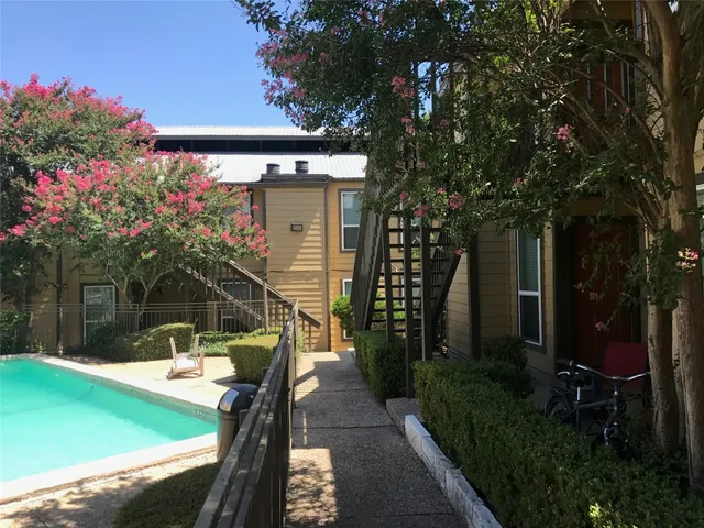 a backyard of a house with lots of green space and glass windows
