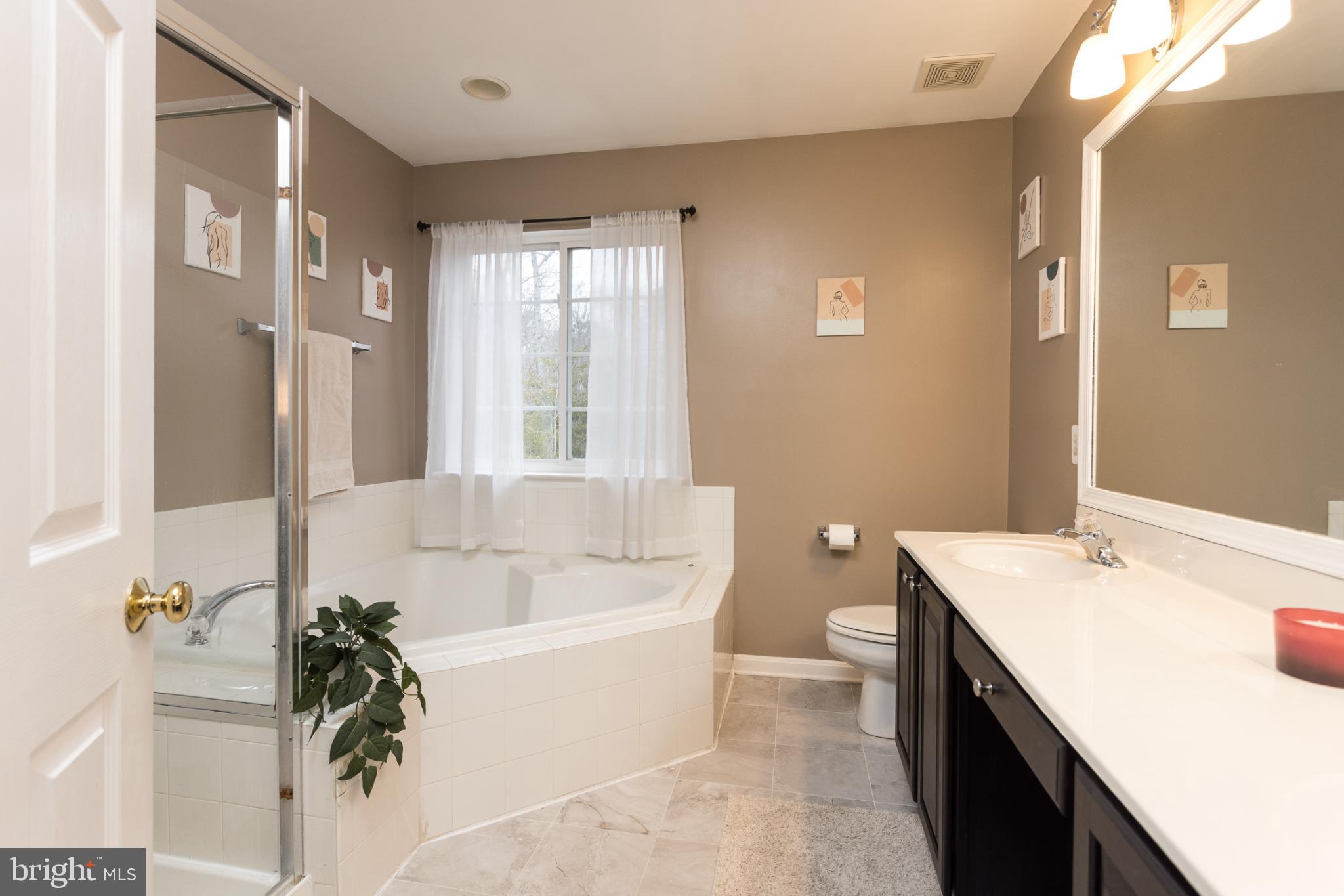 3013 Raking Leaf Drive Abingdon, MD 21009 - Photo 15 of 29 a bathroom with a tub sink and mirror