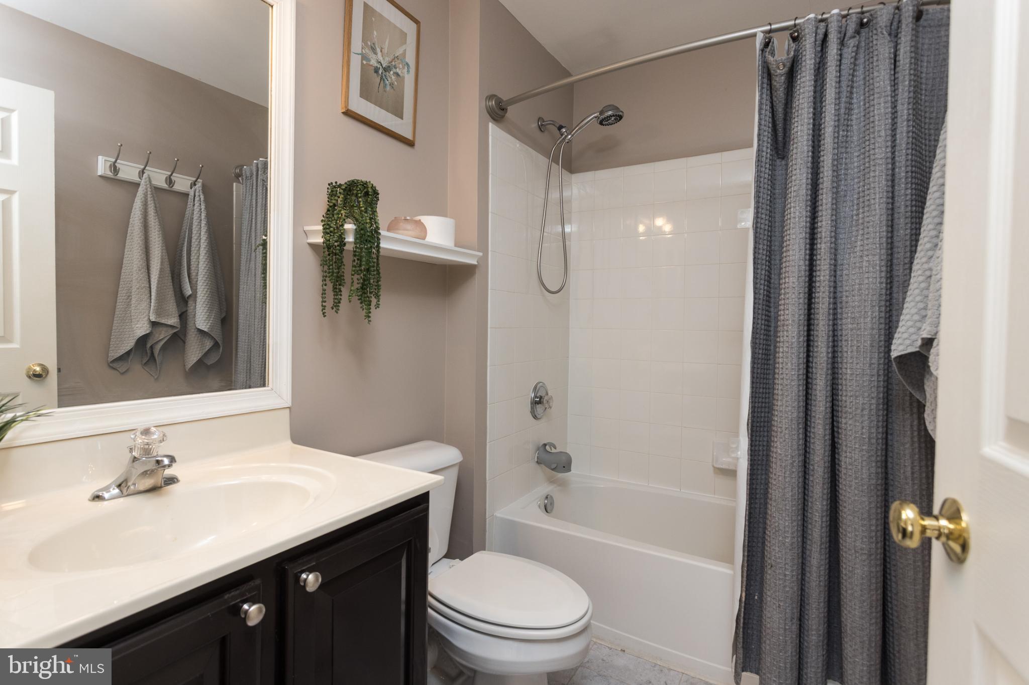 3013 Raking Leaf Drive Abingdon, MD 21009 - Photo 21 of 29 a bathroom with a bathtub shower sink vanity mirror and toilet