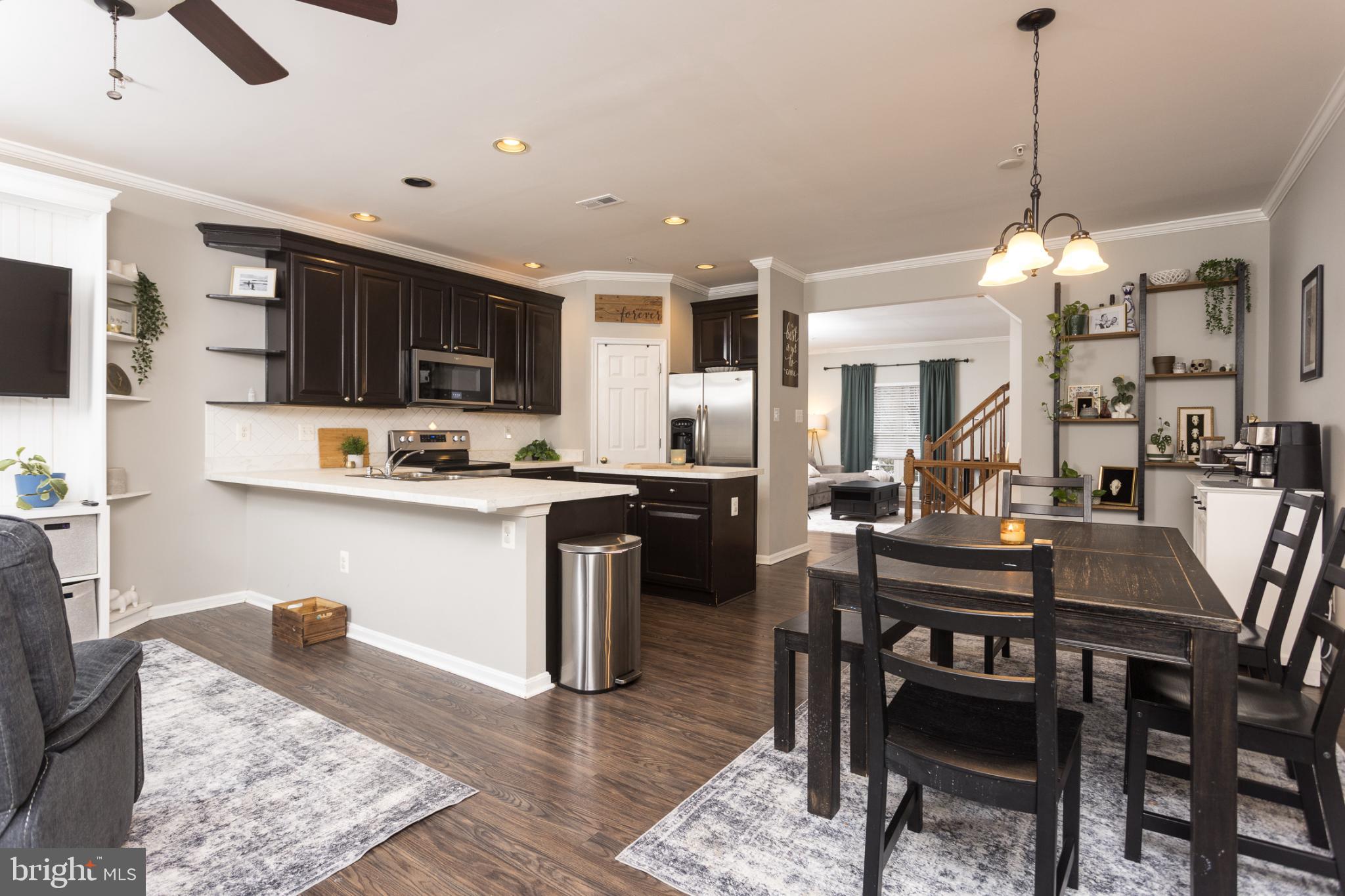 3013 Raking Leaf Drive Abingdon, MD 21009 - Photo 7 of 29 a kitchen with a dining table chairs and a refrigerator