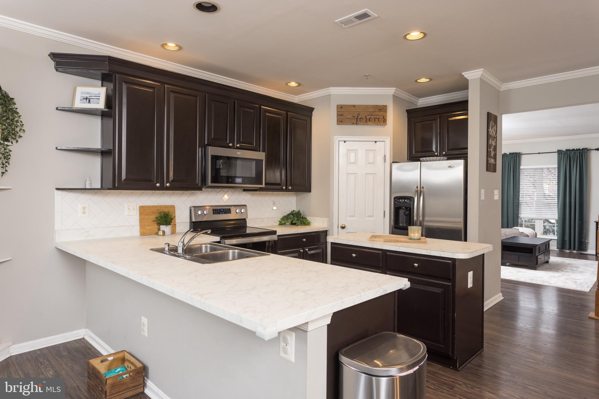 3013 Raking Leaf Drive Abingdon, MD 21009 - Photo 8 of 29 a kitchen with a sink a microwave a stove and refrigerator