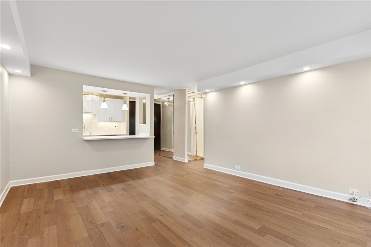 535 North Michigan Avenue, Unit 2204 Chicago, IL 60611 - Photo 4 of 26 a view of an empty room with wooden floor and a window