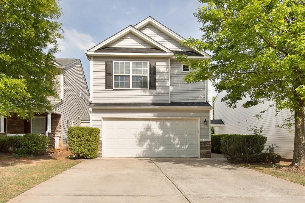 5805 Mountain Top Place, Unit 5805 Cumming, GA 30041 - Photo 1 of 1 a front view of a house with a yard and garage