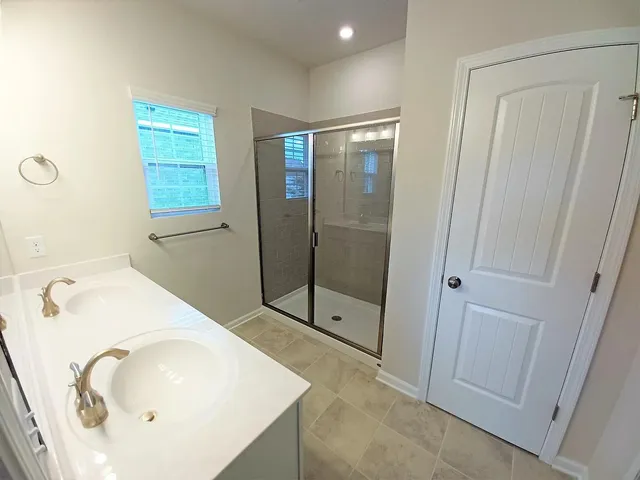 a bathroom with a double vanity sink a and a mirror