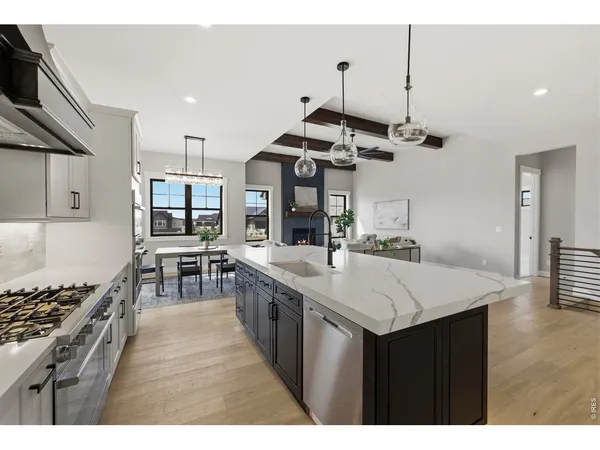 a kitchen with stainless steel appliances kitchen island a large island in the center