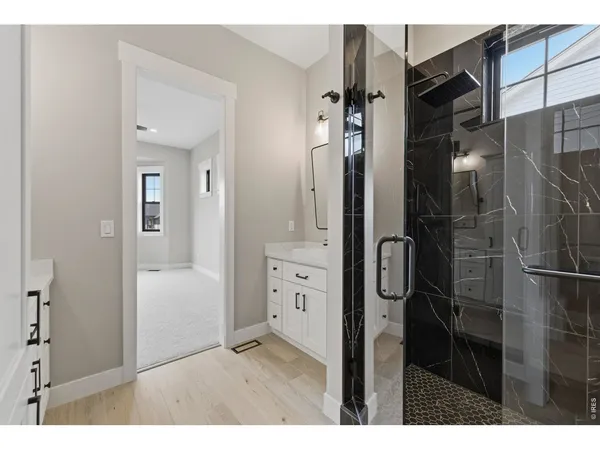 a bathroom with a double vanity sink and mirror