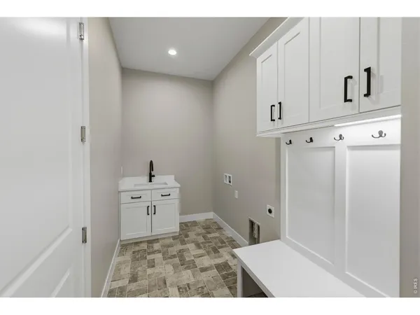 a view of a hallway with cabinet and mirrors