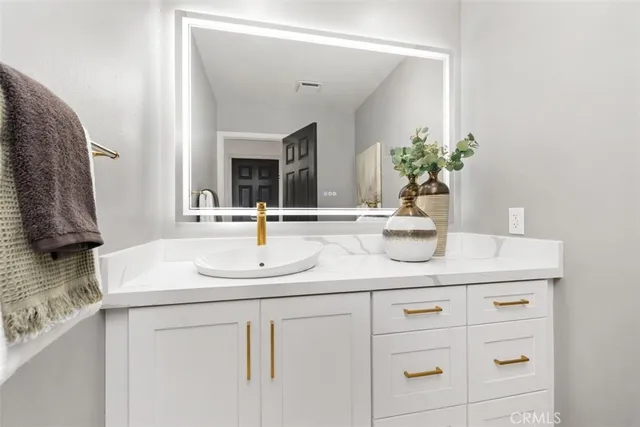 a bathroom with a sink and a mirror