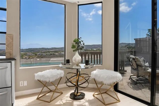 a living room with furniture and a floor to ceiling window