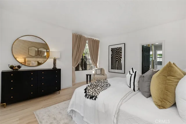 a bedroom with a bed and a dresser