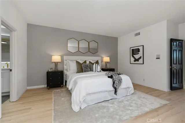 a bedroom with a bed and a painting on the wall