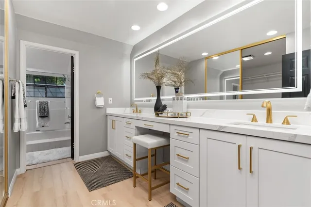 a bathroom with a sink vanity and mirror