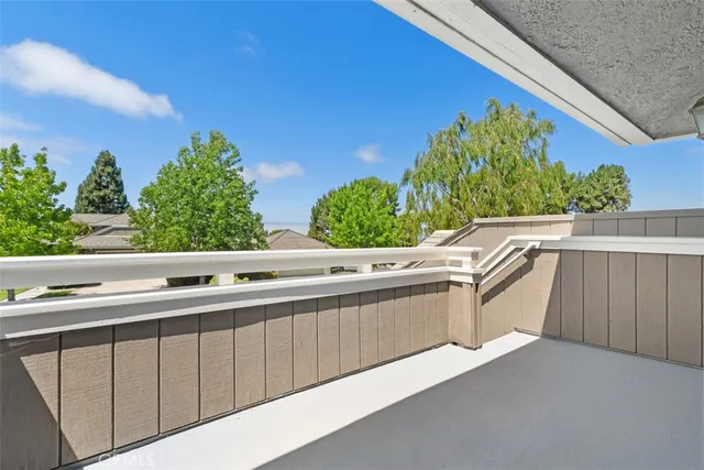 a view of staircase with wooden floor and white walls
