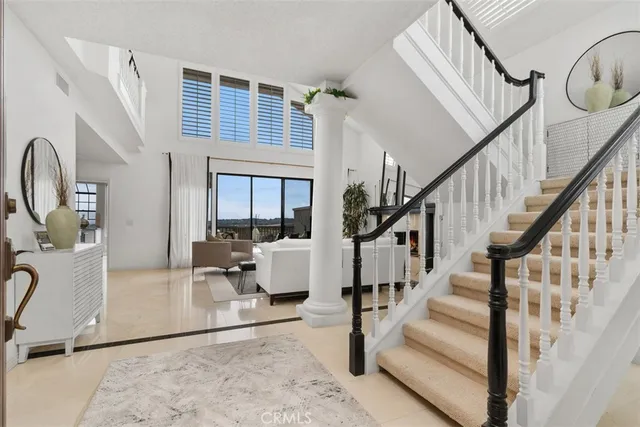 a living room with wooden floor and a dining table