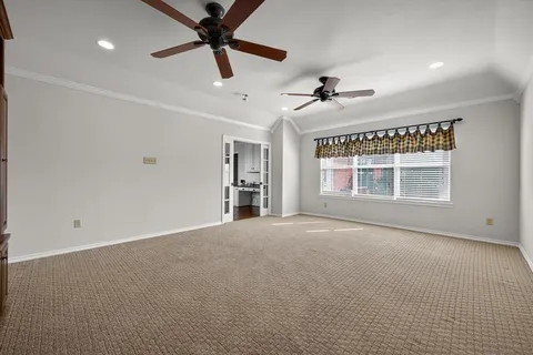 a spacious bathroom with a double vanity sink a mirror a bathtub and a window