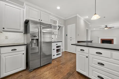 a kitchen with stainless steel appliances a refrigerator and a stove top oven