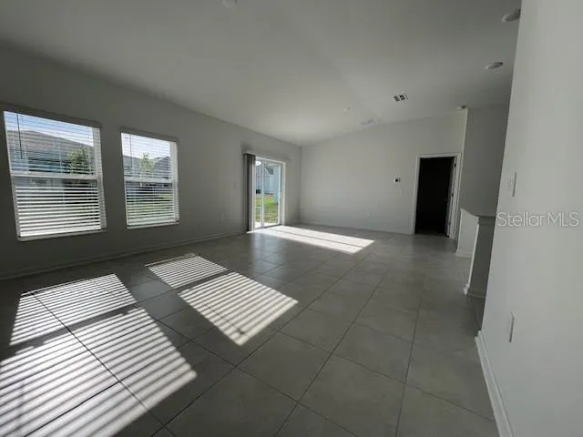 a view of wooden floor and windows in a room
