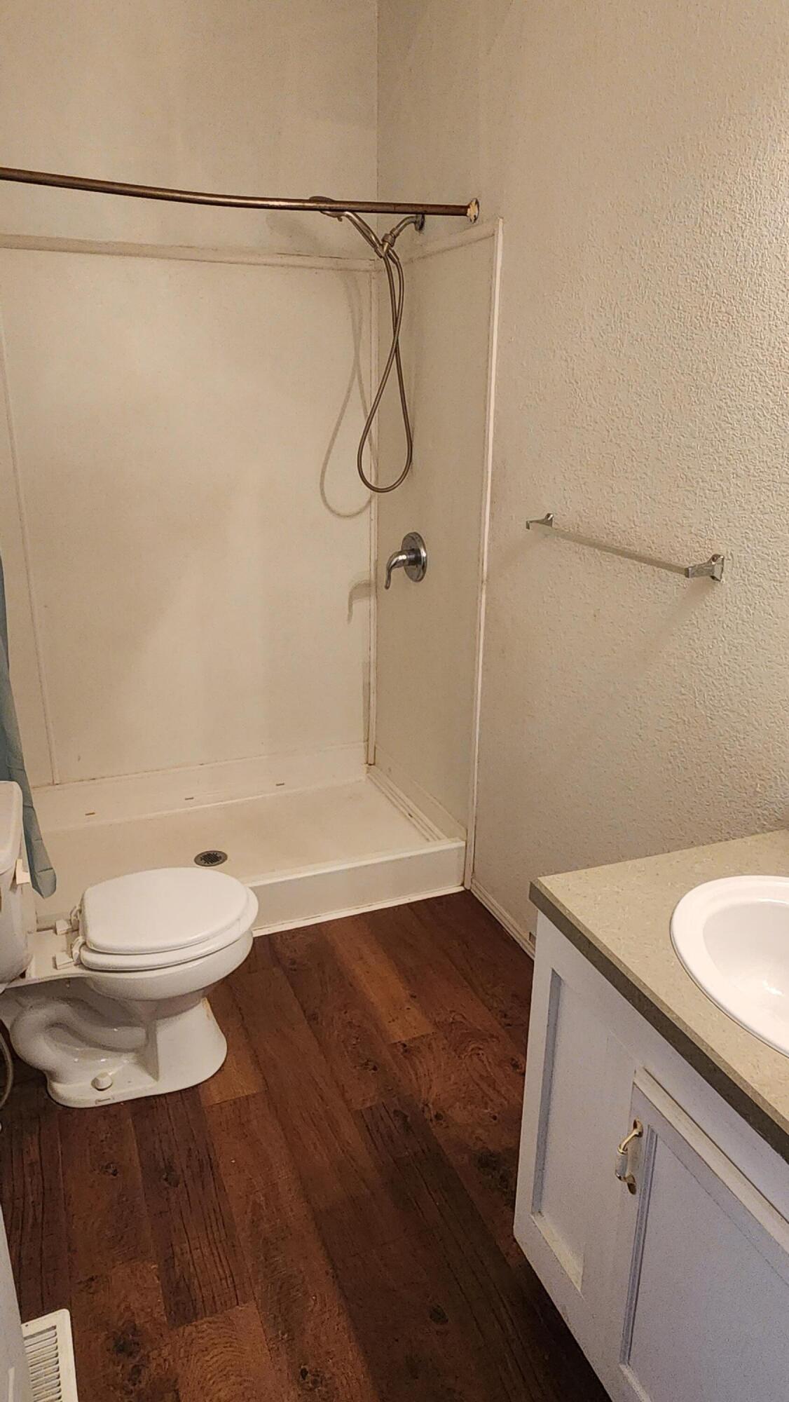 3641 Dawn Road Rosamond, CA 93560 - Photo 12 of 33 a bathroom with a granite countertop shower and a toilet